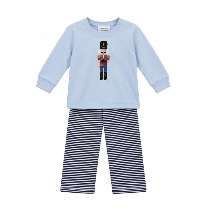 A two-piece children's outfit set from the brand 'Squiggles' featuring a light blue long-sleeve top with a colorful nutcracker graphic on the chest, paired with navy and white horizontally striped pants.