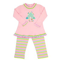 A two-piece children's legging set featuring a light pink long-sleeve top with a colorful gingerbread house applique on the chest, a green and pink ruffled collar and hem, and matching pink, green, and yellow striped pants. | Girls Pink Cookie House Pants Set by Squiggles