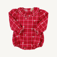 A red plaid long-sleeve baby top with white and green grid lines, featuring a ruffled collar, white bow motifs, and elasticated cuffs and hem, shown flat on a light cream background.