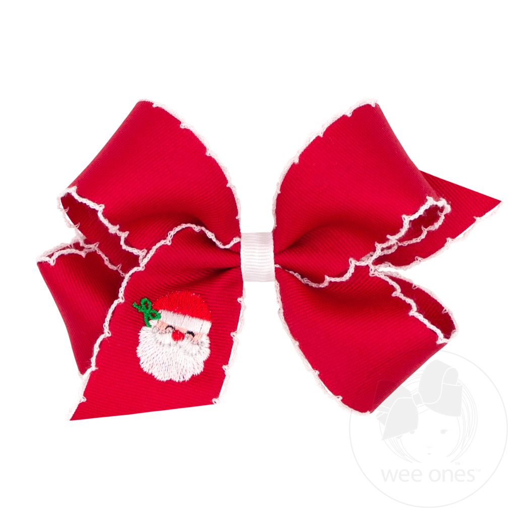 A red grosgrain ribbon hair bow with white scalloped trim and a small embroidered Santa Claus face on the left loop, shown on a white background.