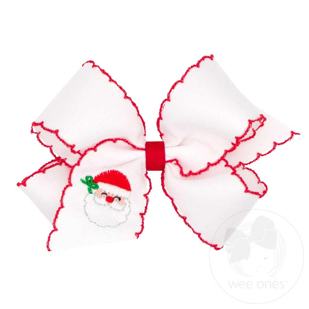 A white grosgrain ribbon hair bow with red scalloped edges and a small embroidered Santa Claus face on the left loop, shown on a white background.