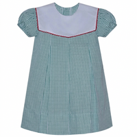 A short-sleeve gingham dress featuring a green and white gingham pattern, a solid white collar with red piping trim, and puffed sleeves.