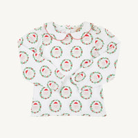 A white long-sleeve baby top with a Peter Pan collar, featuring an all-over print of green wreaths with red berries and Santa hats. The collar is finished with a red stitched trim.