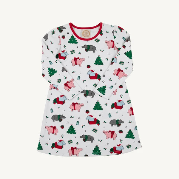 A long-sleeve white nightgown with a red crew neck collar, featuring a festive Christmas print of hippos pigs in red suits, green Christmas trees, and small gift boxes, displayed on a light cream background.