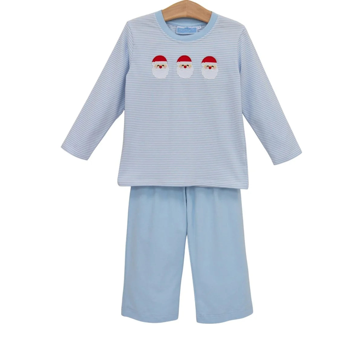 A two-piece children's pant set on a wooden hanger, featuring a light blue and white striped long-sleeve top with three embroidered Santa Claus faces, paired with matching light blue shorts.