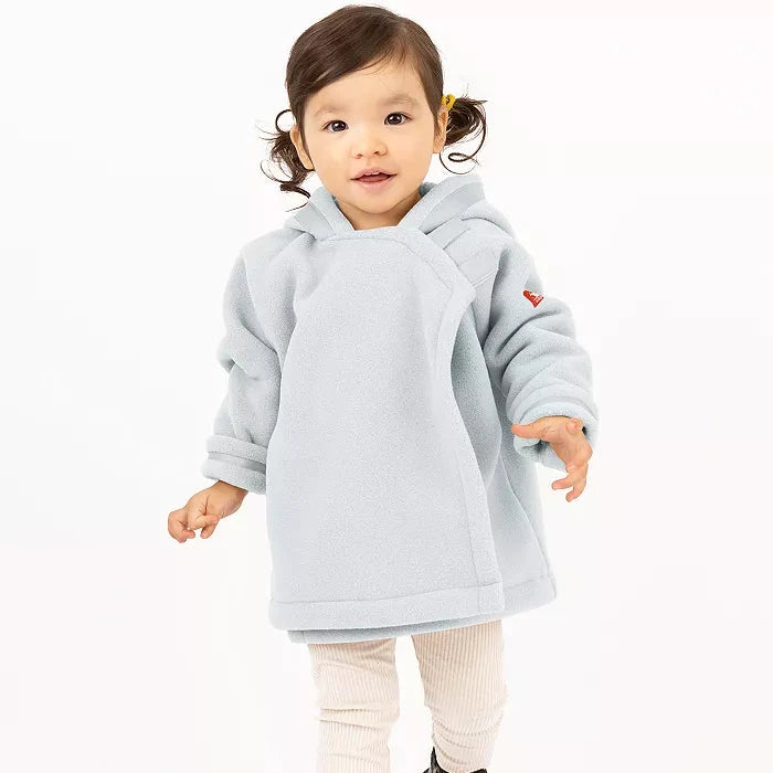 Child wearing a light gray jacket and white pants on a white background
