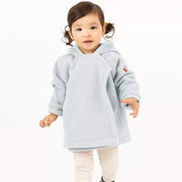 Child wearing a light gray jacket and white pants on a white background